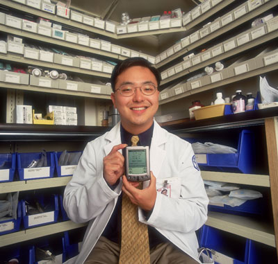 Peter Hahn, resident at Cornell Medical Center proudly displaying the Palm Pilot he uses as a drug database.
